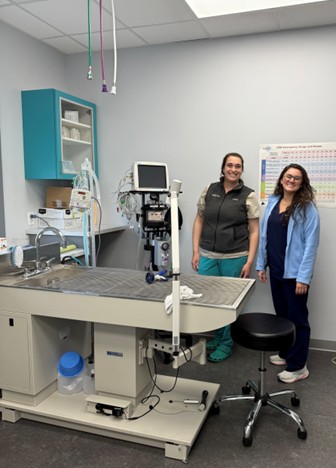 Two people standing in an exam room